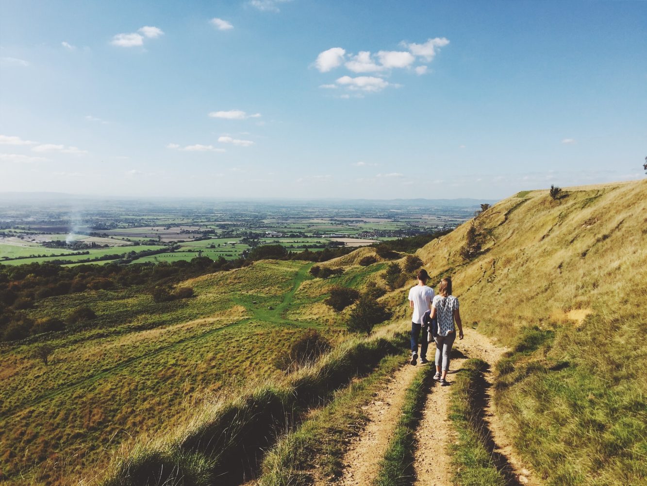 a couple walking along the Cotswolds way